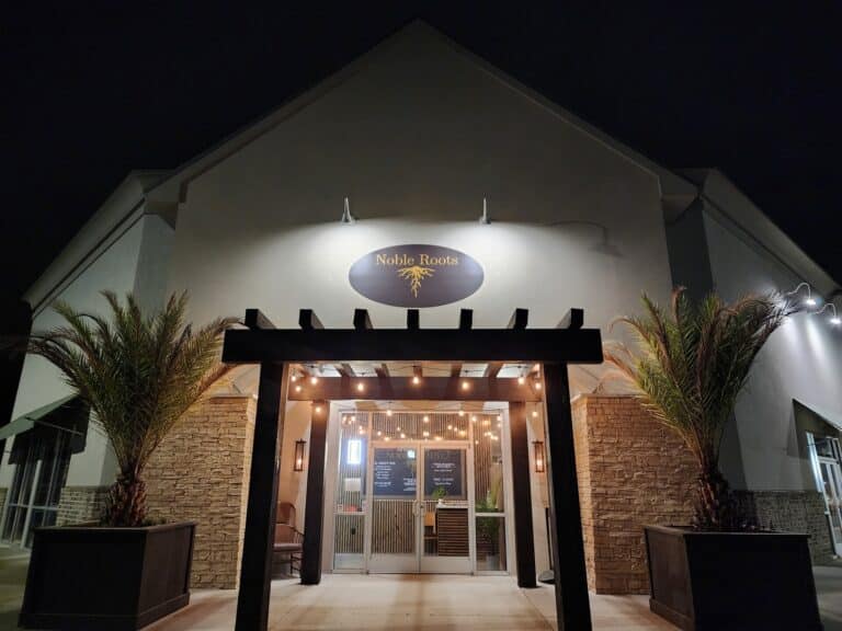 Oliver's Bistro (EN-US) 1 Entrance to Noble Roots self-pour wine bar in Pooler, GA at night